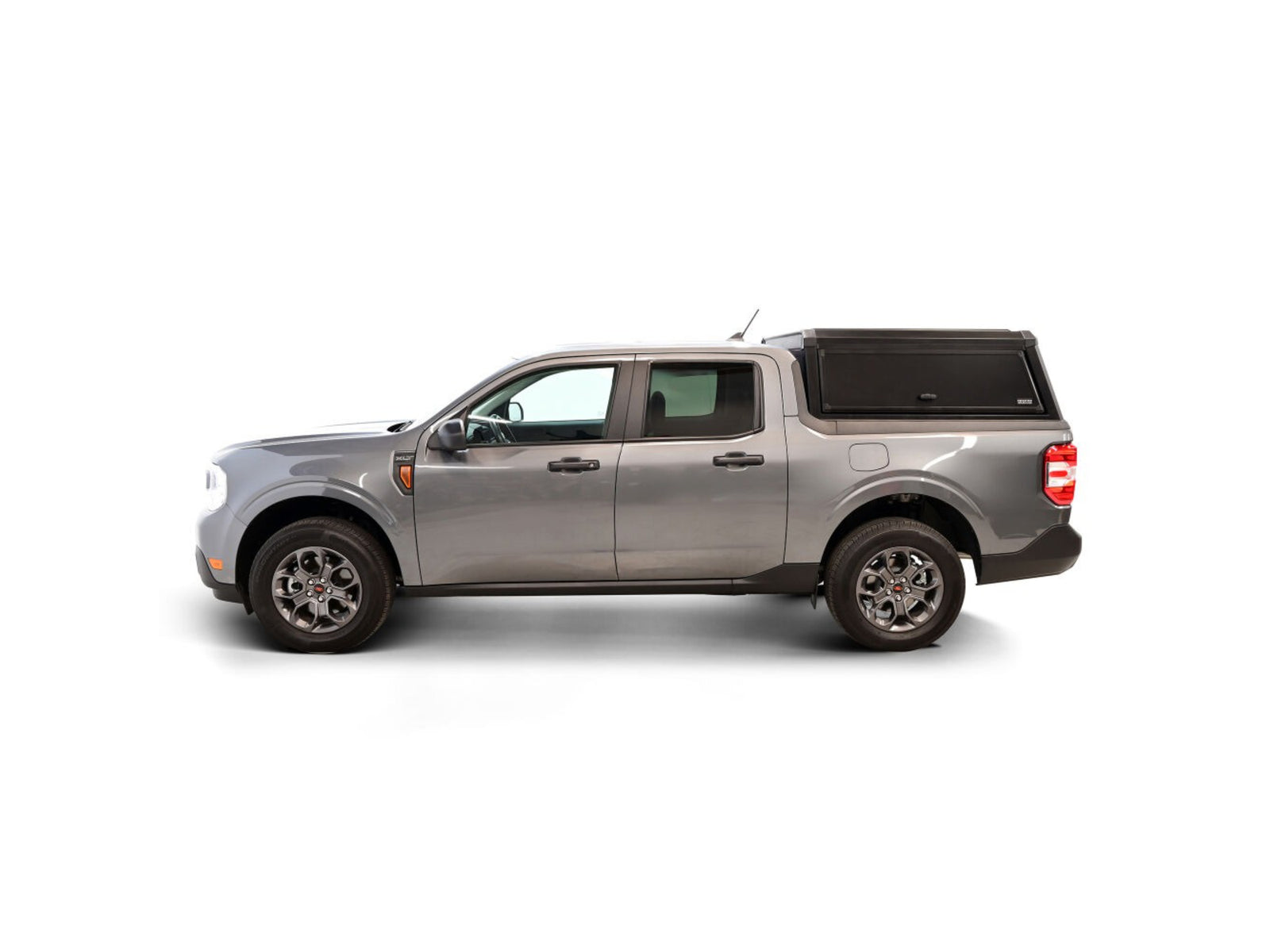 Silver pickup truck with a EXP Truck Cap Hi-Top with Solid Front Glass Matte Black