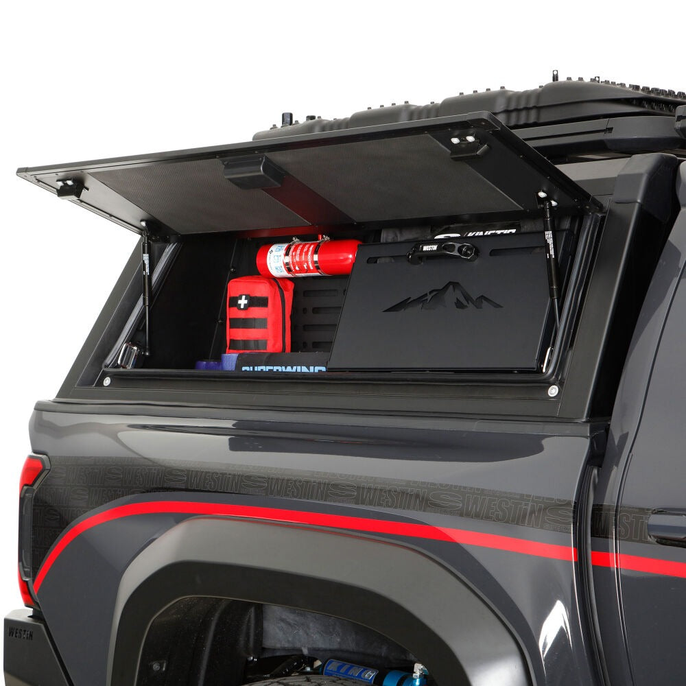 Truck bed with open cargo area showing red and black equipment