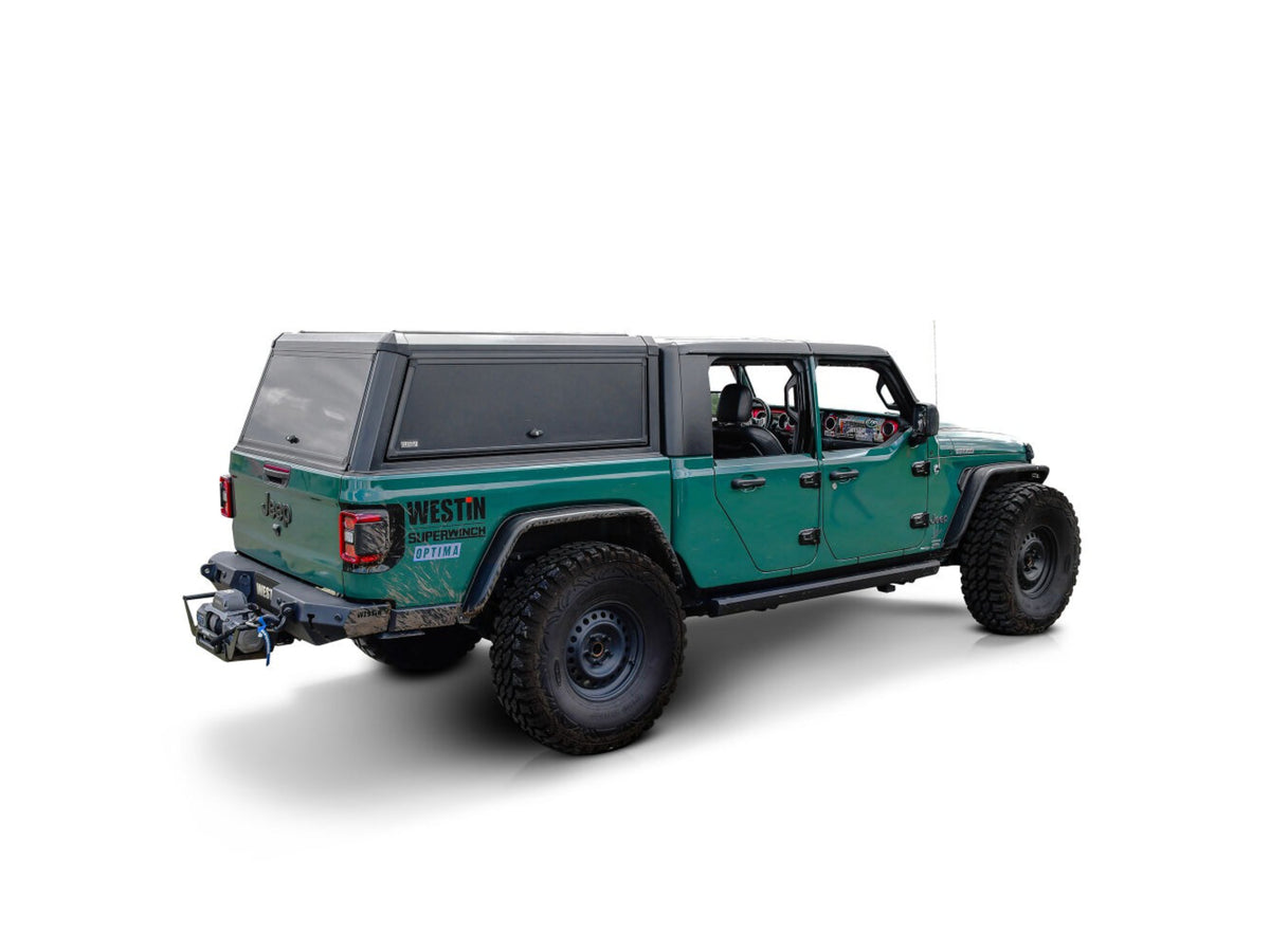 Green Jeep Gladiator with westin exp truck cap on a white background
