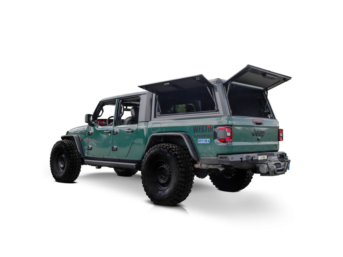 Green Jeep Gladiator with westin exp truck cap on a white background